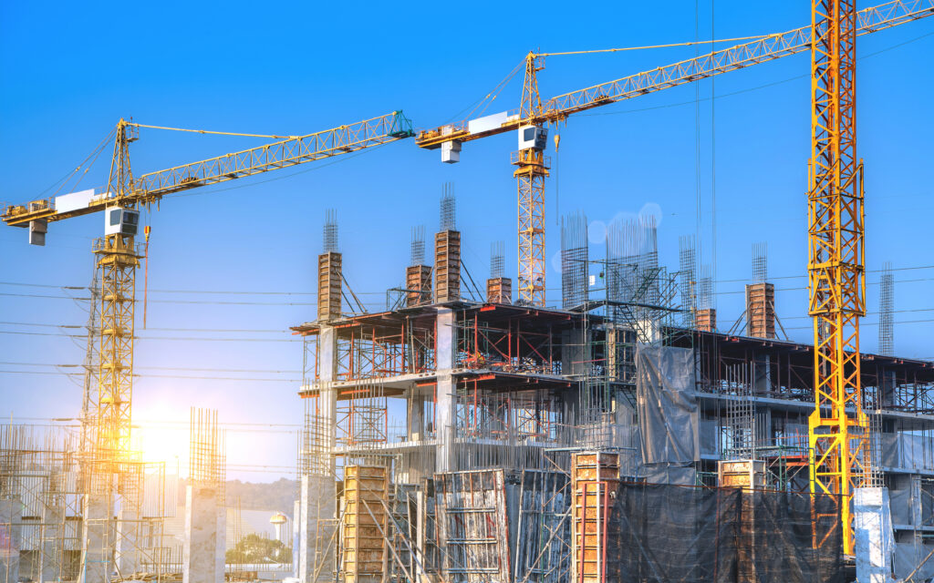 Workers are working on large construction sites and many cranes Hotel Construction Site